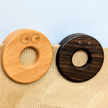 Load image into Gallery viewer, Two wooden Clips one brown and one dark brown, on a beige paper bag with a light blue background. | Hadley Green Home