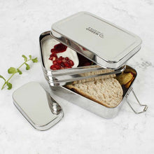 Load image into Gallery viewer, A stainless steel two tier lunch box with a mini container inside, displayed with its lid off, showing compartments with food. | Hadley Green Home