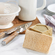 Load image into Gallery viewer, Bar of soap and loofah on a kitchen counter with utensils and dishes in the background. | Eco Living | Hadley Green Home