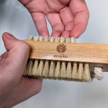 Load image into Gallery viewer, Hand holding a wooden brush with natural bristles and 'ecojiko' branding on a light background | Hadley Green Home