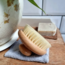 Load image into Gallery viewer, Wooden Ecojiko brush on a towel with soap in the background | Hadley Green Home