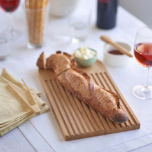 Load image into Gallery viewer, Baguette on a wooden cutting board with glasses of red wine and a bowl of butter in the background. | Hadley Green Home