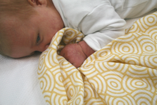 Load image into Gallery viewer, baby with a MuslinZ Muslin gold print swaddle | Little Twidlets