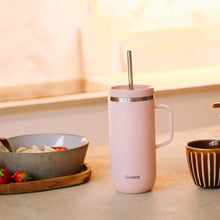 Load image into Gallery viewer, Pink insulated mug with handle on a kitchen counter with a bowl of fruit and a wooden tray. | Little Twidlets