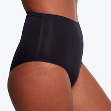 Load image into Gallery viewer, Close-up side view of a model wearing high-waisted black period briefs against a clean white background. | Hadley Green Home