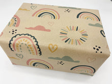 Load image into Gallery viewer, Box wrapped in brown paper with colorful rainbow and cloud pattern on a white background | Hadley Green Home