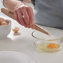 Load image into Gallery viewer, Person cracking an egg into a glass bowl with wooden tongs | Hadley Green Home
