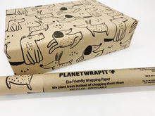 Load image into Gallery viewer, Eco-friendly wrapping paper with animal designs and a roll of Planetwrapit brand paper on a white | background. | Hadley Green Home
