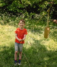 Load image into Gallery viewer, Child in an orange shirt holding a Den Kit Pully Kit in a  grassy outdoor setting | Hadley Green Home
