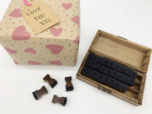 Load image into Gallery viewer, Set of wooden stamps with a decorative box and heart-patterned paper in the background. |  Hadley Green Home
