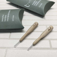 Load image into Gallery viewer, Two interdental brushes with packaging on a tiled surface | Little Twidlets
