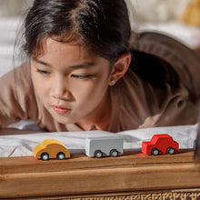 Load image into Gallery viewer, Child playing with toy cars on a wooden surface | Plan Toys | Hadley Green Home
