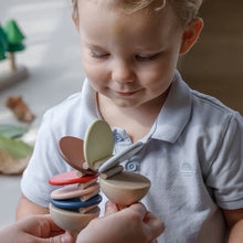 Load image into Gallery viewer, Child playing with a wooden Plan Toys Clatter from Plan Toys in a cozy indoor setting | Hadley Green Home

