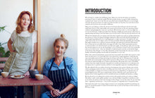 Load image into Gallery viewer, Two women in aprons standing next to a table with text on the right side, Use It All Cookbook | Hadley Green Home
