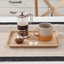 Load image into Gallery viewer, French press with coffee and a mug on a wooden tray on a table.
