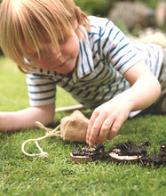 Load image into Gallery viewer, Child building a bird pizza kit from the Den Kit Co on the grass | Hadley Green Home
