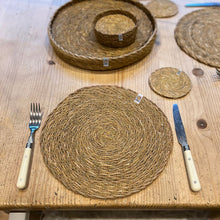Load image into Gallery viewer, Woven placemats and coasters on a wooden table with cutlery. Respiin | Hadley Green Home
