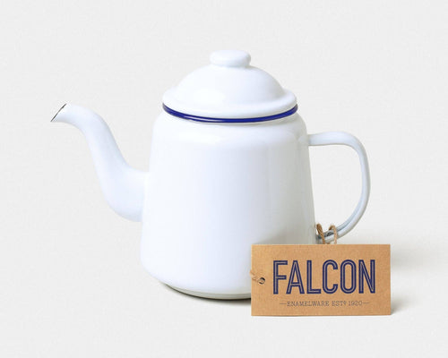 White teapot with blue rim and handle, accompanied by a 'Falcon' branded tag on a light background | Hadley Green home
