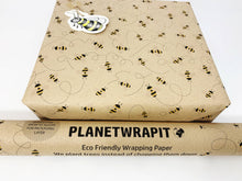 Load image into Gallery viewer, Roll of eco-friendly wrapping paper with bee design and 'Planetwrapit' branding. | Hadley Green Home
