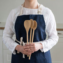Load image into Gallery viewer, Person wearing a navy apron holding wooden spoons in a kitchen setting | Little Twidlets
